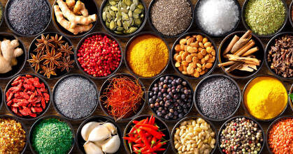 Colourful background from various herbs and spices for cooking in bowls. Top view