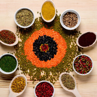 Colorful spices  in spoons and on wooden table